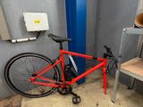 a red bike that is parked in a garage