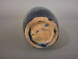 a close up of a blue vase on a table