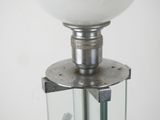 a lamp that is on top of a glass stand