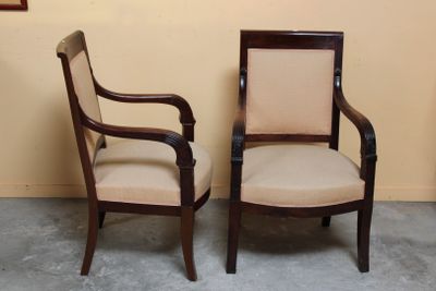 two chairs sitting next to each other in a room