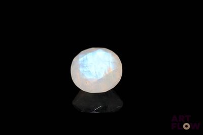 a close up of a white stone on a black surface