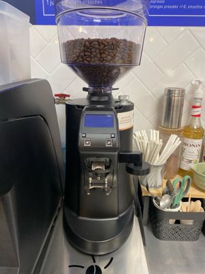 a coffee grinder sitting on top of a counter