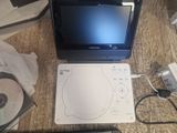 a laptop computer sitting on top of a table next to a cd player