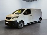 the small white van is parked in a large room