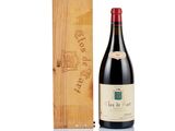 the bottle of wine is next to a wooden box