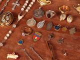 a wooden table with a bunch of jewelry on it