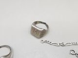 a silver ring with a chain attached to it