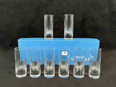 six shot glasses in a blue box on a black background
