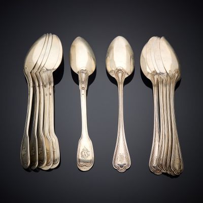 four silver spoons and two silver spoons sitting side by side