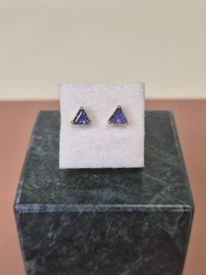 a close up of a pair of earrings sitting on top of a box