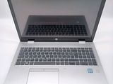 a laptop computer that is open on a white surface