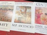 three posters on a table with pictures of people on them
