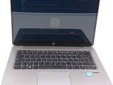 a laptop computer that is open on a white surface