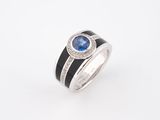 a white gold ring with a blue sapphire and diamonds