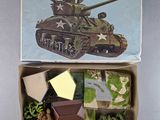 an image of a box with a toy army tank in it
