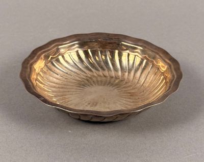 an image of a silver bowl sitting on top of a table