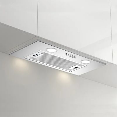 a white kitchen with a stainless steel range hood and lights