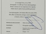 a close up of a certificate with a picture of a person holding a camera