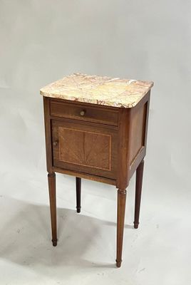 a small wooden table with a marble top on it