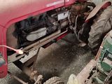a red tractor that is parked in a garage