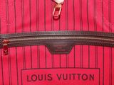a close up of a red louis vuitton bag