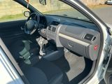 a car with the door open sitting in a parking lot