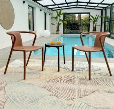 deux chaises et une table devant une piscine