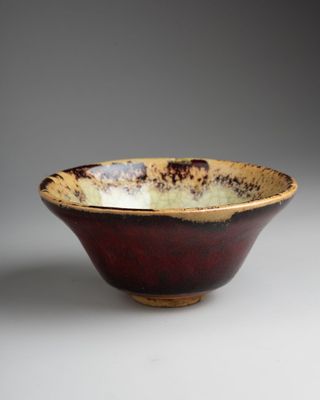 a close up of a bowl on a table with a gray background