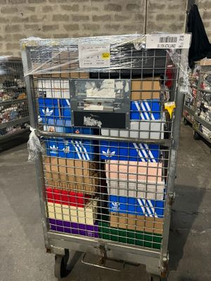 a metal cart with many boxes on it in a store