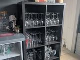 a shelf with wine glasses on it in the kitchen
