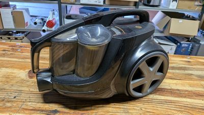 a black and silver vacuum on a wooden table