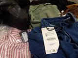 a pile of clothes that is sitting on the floor