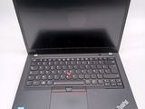 the laptop is open on a white surface with a black keyboard