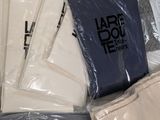 many bags of clothing that are on a table