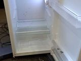 an open refrigerator that is sitting in a room