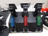four different colored springs on the front of a game controller