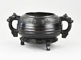 a black pot with handles on a stand on a white background