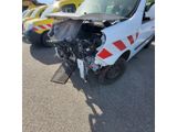 a car that has been badly damaged and is sitting in the parking lot