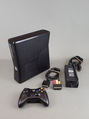 a video game console and a game controller on a table