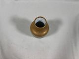 a small gold vase on a white table cloth
