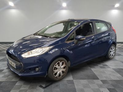 a blue ford fiesta parked on a checkered floor in a garage