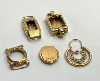several pieces of gold jewelry are displayed on a white surface