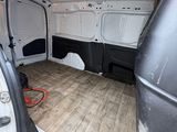 the inside of a van with the door open showing the wood flooring