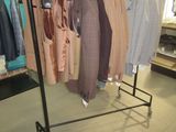 a lot of clothes hanging on a rack in a store