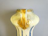 un vase jaune et bleu posé sur une table
