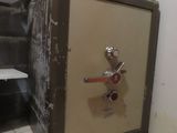 a safe box sitting on a tiled floor in a room