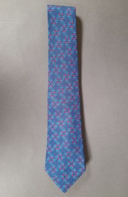 a close up of a tie on a table next to a cup of coffee