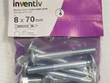 an assortment of screws and nuts in a package on a table