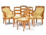 a group of chairs and a stool in a room