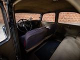 an old car with a bed in the back of it
